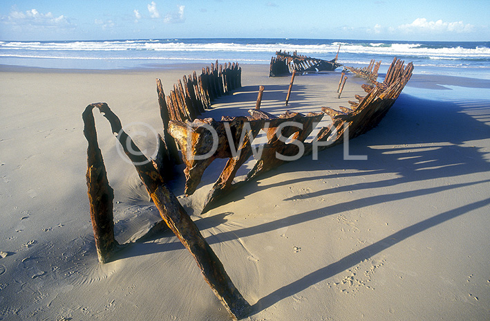 stock photo image: Australia, qld, queensland, beach, beaches, seashore, seashores, wreck, wrecks, shipwreck, shipwrecks, ss dicky, rust, rusts, rusted, rusting, coast, coasts, coastline, coastlines.