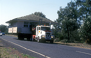 Australia, transport, transportation, vehicle, vehicles, truck, trucks, house, houses, housing, move, moves, moving, moving house, move, moves, moving, road, roads, sealed, sealed road, sealed roads, sign, signs, roof, roofs, rooves, tree, trees, window, windows.