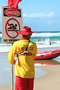 Australia, qld, queensland, surfers paradise, gold coast, beach, beaches, lifesaver, lifesavers, lifesaving, sign, signs, danger, danger sign, danger signs, warning sign, warning signs, safety, man, men, male, males, occupation, occupations, hat, hats, circle, circles, circular.