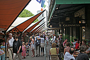 Australia, nsw, sydney, architecture, the rocks, people, crowd, crowds, pub, pubs, hotel, hotels, furniture, table, tables, chair, chairs, umbrella, umbrellas, flag, flags, market, markets, stall, stalls, market stall, market stalls, sign, signs.