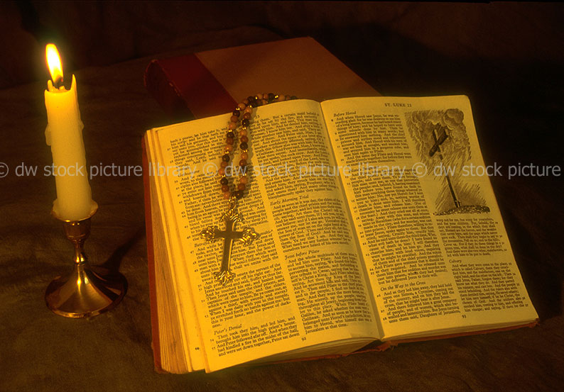 stock photo image: Book, books, paper, bible, bibles, holy bible, holy bibles, religion, religious, candle, candles, rosary, rosary bead, rosary beads, cross, crosses, flame, flames.