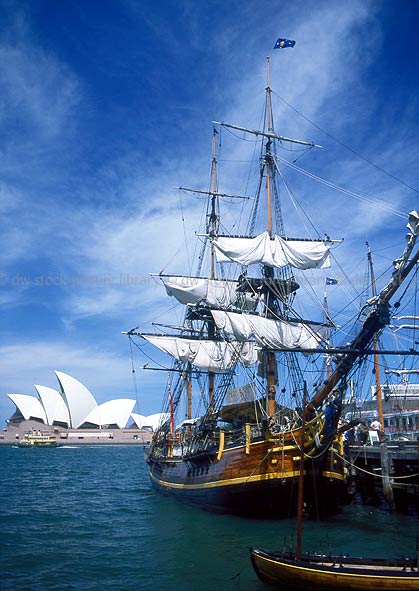 stock photo image: Australia, New South Wales, Sydney, Sydney Harbour, Sydney Harbor, Sydney Opera House, Architecture, Joern Utzon, opera house, bounty, hms bounty, the bounty, cloud, clouds, sky, skies, sky scenes, ship, ships, sailing ship, sailing ships, early sailing ship, early sailing ships.