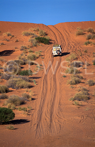 stock photo image: Australia, Australian, Australian desert, Australian deserts, transport, transportation, vehicle, vehicles, Car, Cars, Vehicle, Vehicles, four wheel drive, four wheel drives, 4wd, 4wds, 4-wheel drive, 4-wheel drives, outback, dune, dunes, sand dune, sand dunes, NT, Northern Territory, australia, unsealed road, unsealed roads, australian outback, outback australia, desert, deserts, desert scenes.