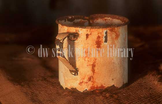 stock photo image: Cup, cups, tin cup, tin cups, drinking vessel, drinking vessels, rust, rusts, rusting, mug, mugs, tin mug, tin mugs.