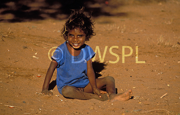 stock photo image: People, australia, child, children, aborigine, aborigines, aboriginal, aboriginals, aboriginal child, aboriginal children, aborigine child, aborigine children, port hedland, sand, dust, dusty, WA, Western Australia, Australia, smile, smiles, smiling, happy, happiness, indigenous, outback, australian outback, outback australia.