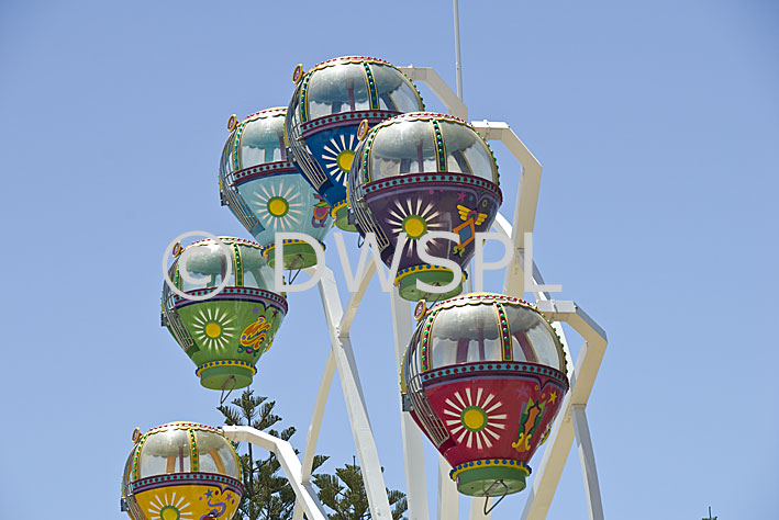 stock photo image: Fair, Fairs, Fairground, Fairgrounds, ferris wheel, ferris wheels, ferriswheel, ferriswheel, fairground ride, fairground rides, fun park, fun parks, wheel, wheels, theme park, theme parks, amusement, amusement ride, amusement rides, amusement park, amusement parks, fun spot, fun spots, circle, circles.