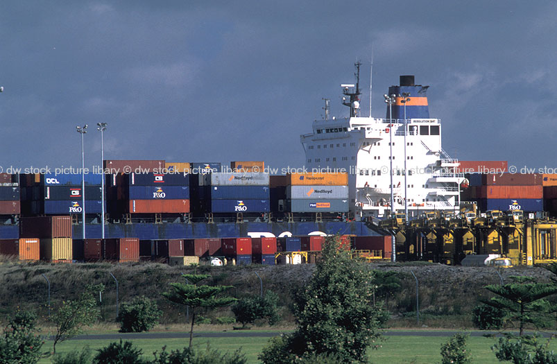 MOORED CARGO SHIP AND CONTAINERS ON DOCKSIDE READY FOR LOADING, PORT
