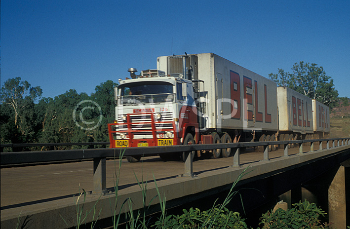 stock photo image: Transport, transportation, vehicle, vehicles, heavy vehicle, heavy vehicles, truck, trucks, semi, semis, semi-trailer, semi-trailers, fence, fences, bell, road train, sign, signs, road trains, roadtrain, roadtrains, vehicle, vehicles, heavy vehicle, heavy vehicles, bellway, australia, nt, northern territory, bridge, bridges, victoria river, river, rivers, victoria.