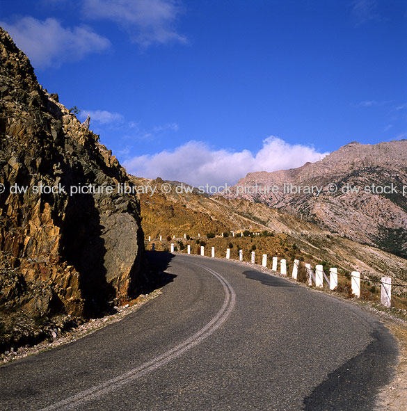 stock photo image: Australia, Tasmania, Tassie, Tas, Queenstown, road, roads, sealed, sealed road, sealed roads, environment, environmental damage, damage, bend, bends, post, posts.