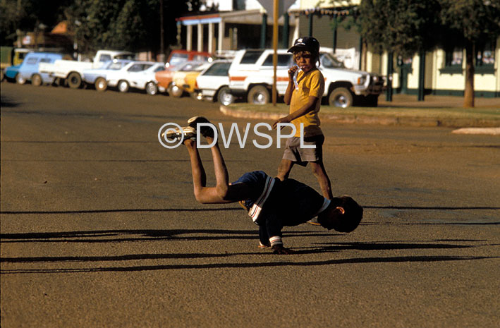 stock photo image: People, child, children, swing, swings, aborigine, aborigines, aboriginal, aboriginals, aboriginal child, aboriginal children, aborigine child, aborigine children, boy, boys, male, males, WA, Western Australia, Australia, dance, dances, dancing, meekatharra.