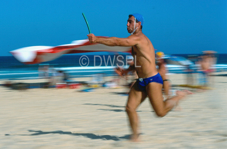 stock photo image: People, Sport pictures, Sports, australia, life saver, life savers, life saving, surf life saver, surf life savers, surf life saving, man, men, sand, male, males, run, runs, running, runner, runners, beach, beaches, coast, coasts.