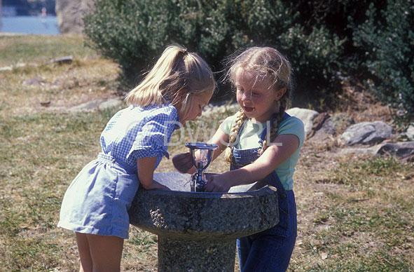 stock photo image: People, child, Children, girl, girls, female, females, girl, girls, bubbler, bubblers, water bubble, water bubblers, waterbubbler, waterbubblers, drinking fountain, drinking fountains, outdoors.